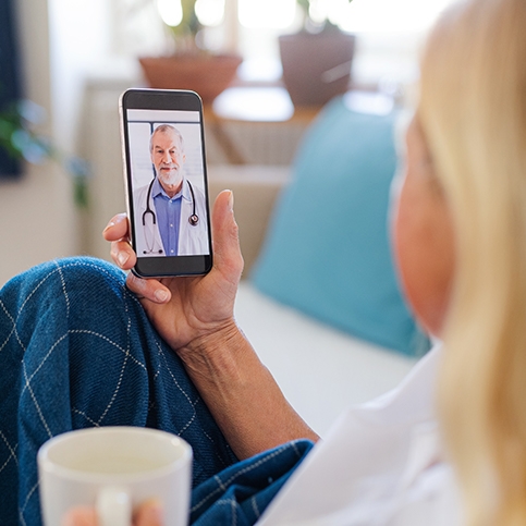 Woman having an online walk-in appointment with a doctor on her phone.